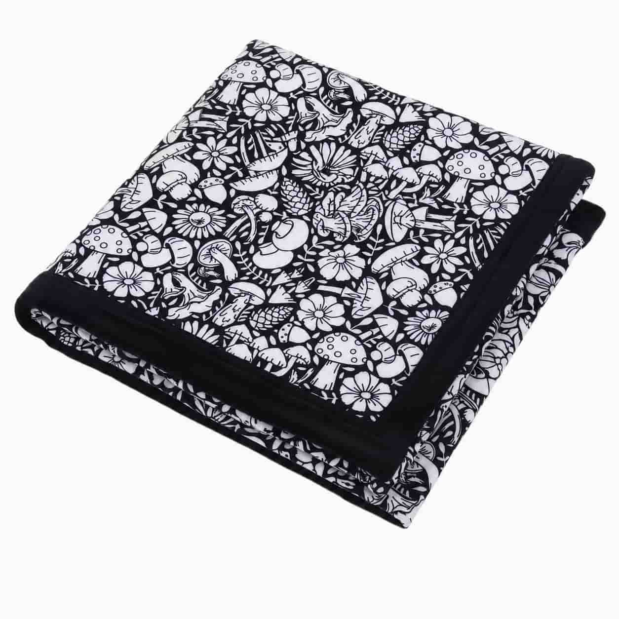 Folded coloring blanket with mushroom and flower print