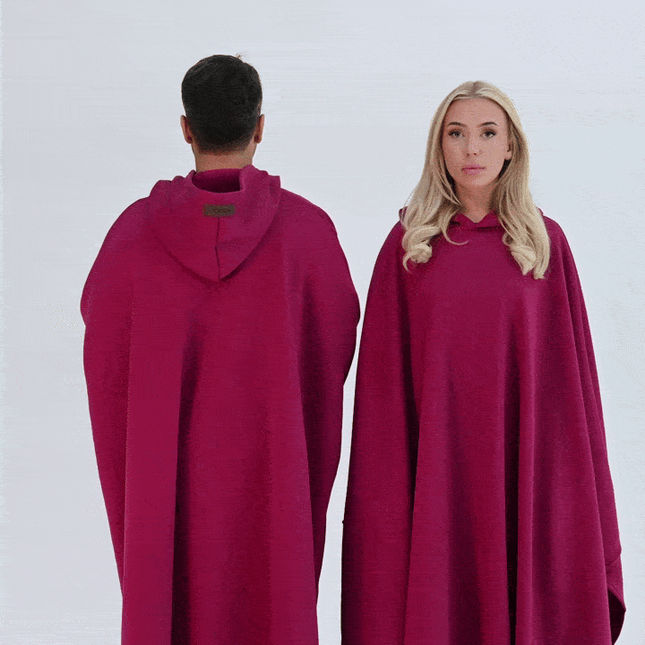 Two people wearing red Hoodly hoodie blankets front and back