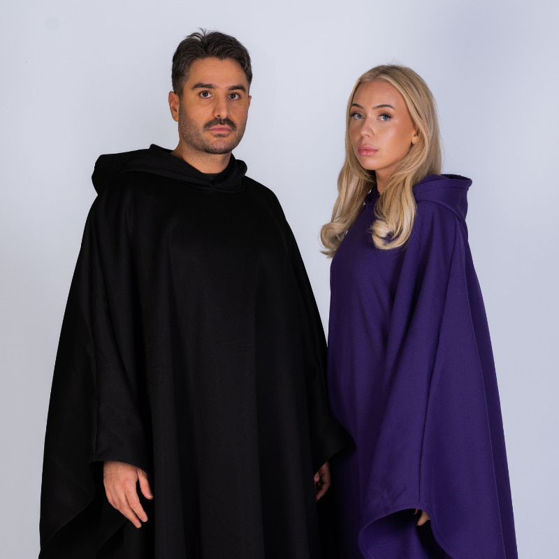 Couple wearing black and purple Hoodly hoodie blankets