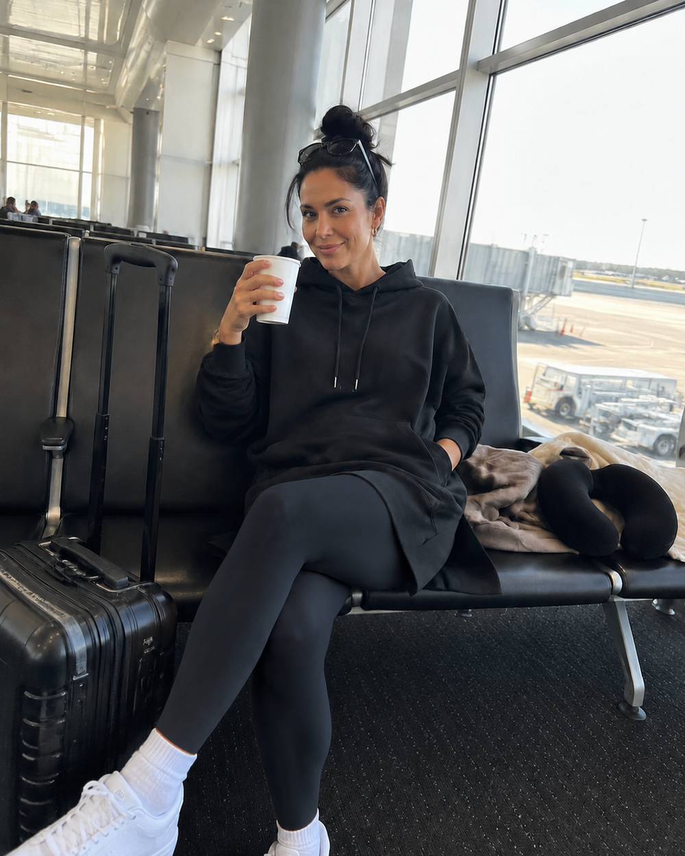 Woman wearing the Wear the Shape hoodie dress at the airport